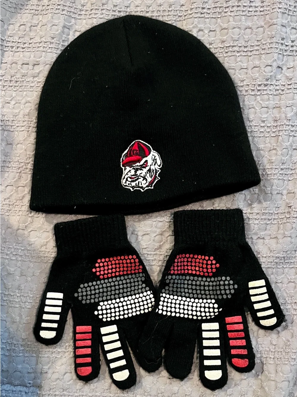 Black UGA Youth Beanie and Grip Gloves Set with Red Bulldog Logo on the back.